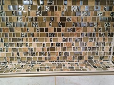 Mosaic tile installation exhibiting misaligned tiles and noticeable gaps, indicating bad workmanship