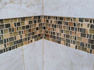 Mosaic tile installation characterized by uneven tiles and visible imperfections, pour craftsmanship