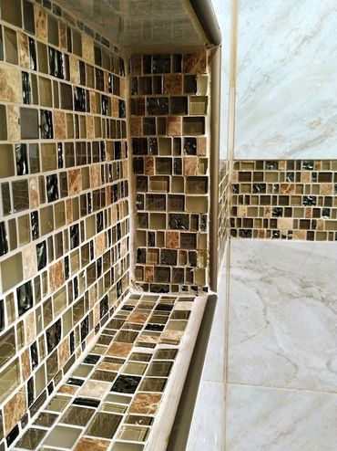 Shower niche with mosaic tiles exhibiting significant craftsmanship errors