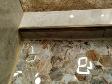 Poorly installed shower pan showing uneven surface and gaps, indicating potential structural issues