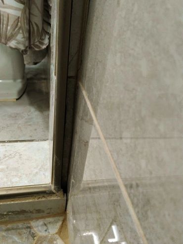 Poorly executed tile work showcasing uneven tile work, pour craftsmanship by unprofessional builders