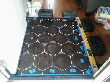Alternative angle of hexagonal porcelain tile dry-fit and perimeter layout in a 3x4 house entrance.