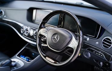 Mercedes S Class in white black leather interior steering wheel
Mercedes for hire in London