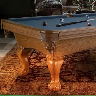 Antique pool table with wooden claw feet