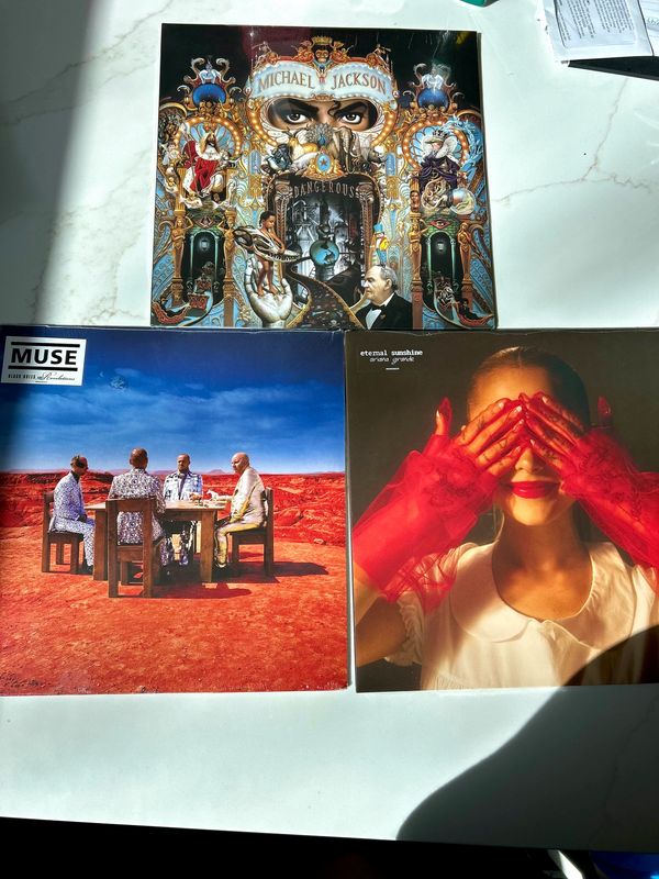 Three vinyl record covers including Michael Jackson's Dangerous, Muse's album, and Eternal Sunshine's album.