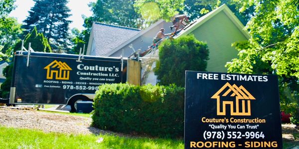 Coutures Construction sign and trailer parked at a clients home