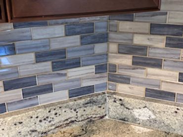 I meticulously installed a stylish and durable backsplash, ensuring precise alignment!
