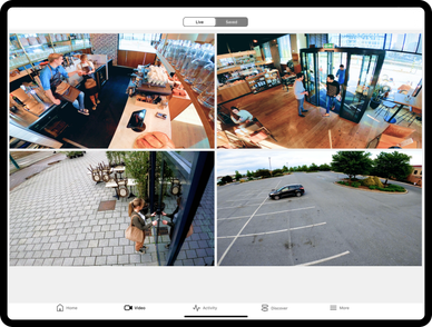 Four security camera views showing a café interior, entrance, outside seating, and a parking lot.