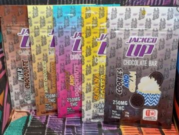 Various flavors of Jacked Up THC chocolate bars displayed in colorful packaging.