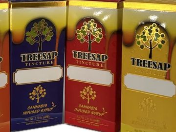Colorful Treesap tincture boxes with cannabis-infused syrup labels.