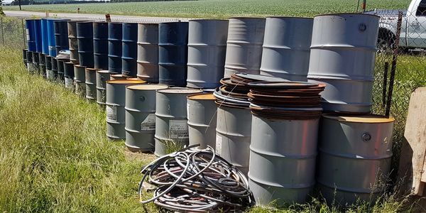 steel drums stacked on job site