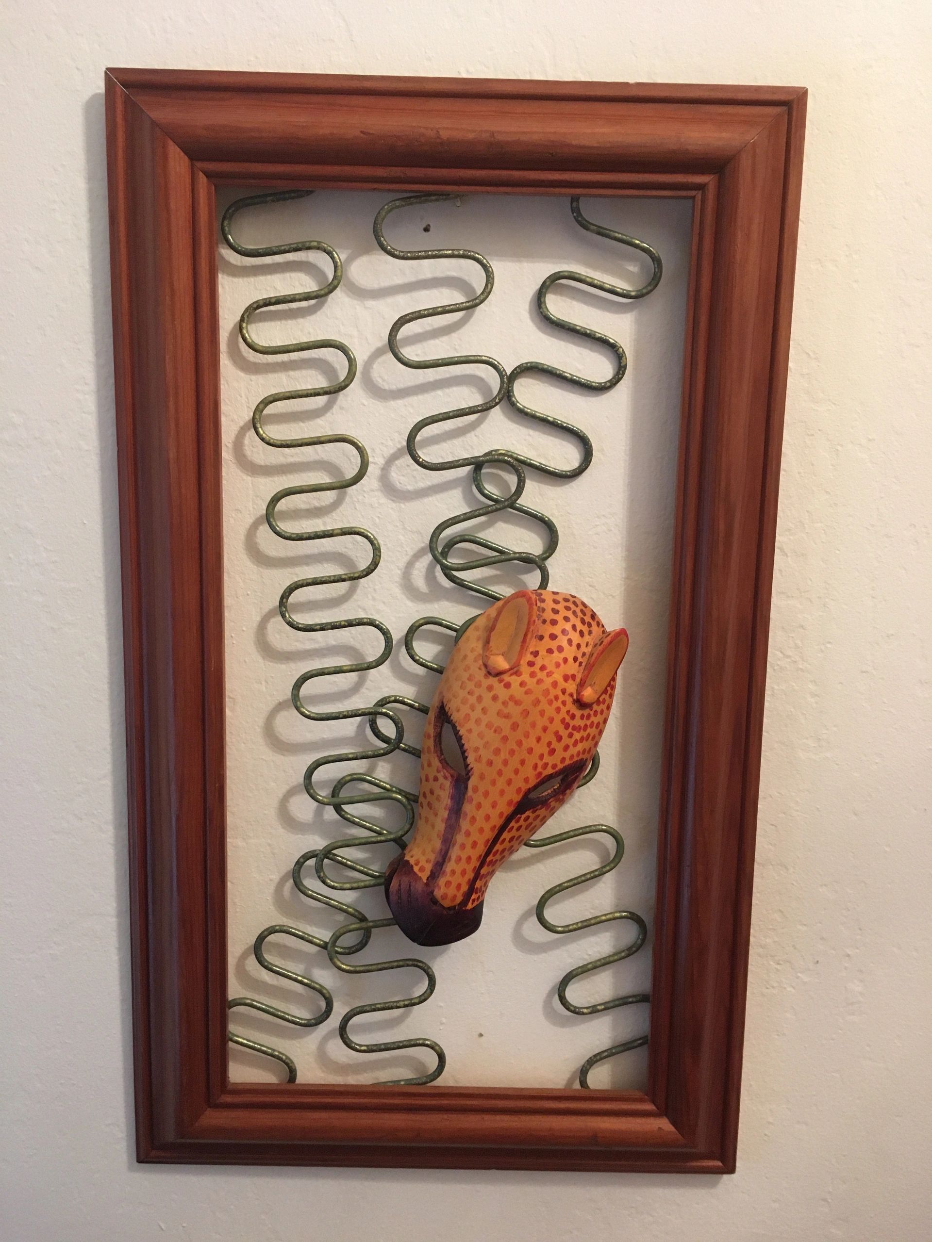 wooden cheetah mask on reclaimed upholstery chair springs mounted in pine frame