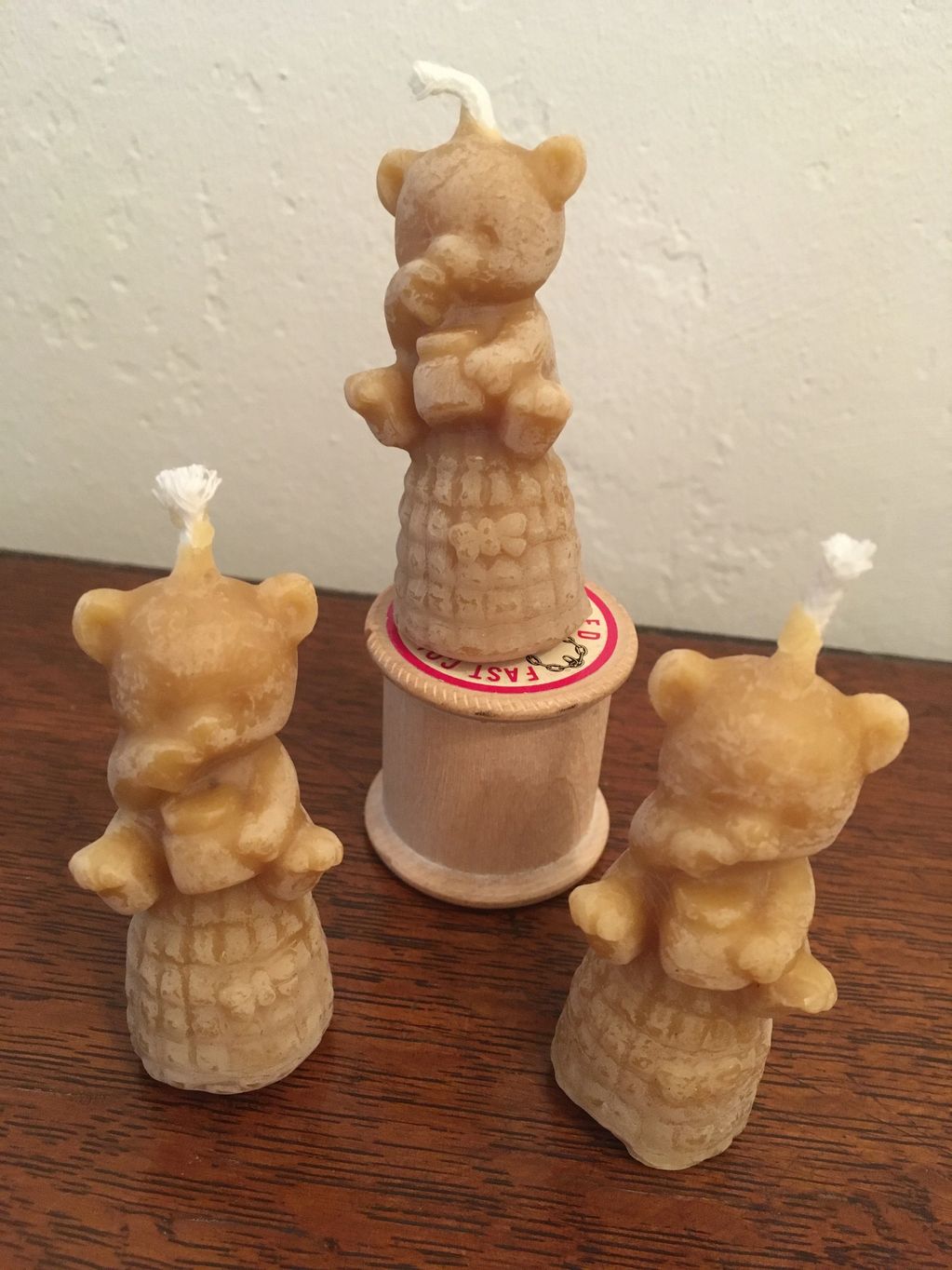 Beeswax bear candles. bear sitting on traditional bee skpe with a honey pot