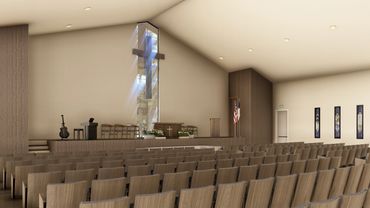 Modern church interior with wooden chairs and a cross-shaped window.