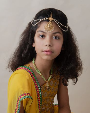 young girls wearing traditional Indian jewelry and clothing