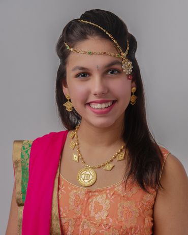smiling teen girl in traditional indian clothing and jewelry