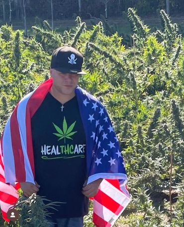 James Diaz Jesus Justice Owner & C.E.O. Of Pirate Farms NY Cannabis wrapped in the American Flag