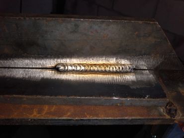 Gold TIG Weld, mild steel plate, 304L stainless filler.