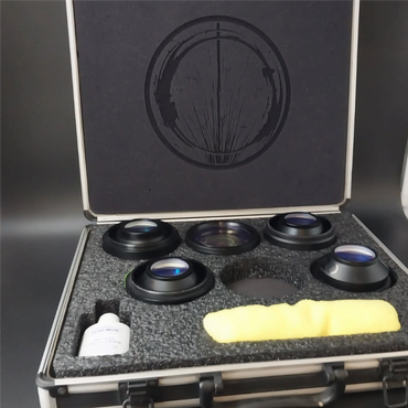A foam-lined case containing five camera lenses and cleaning accessories.