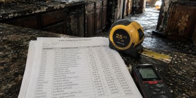 Tape measure and a list of measurements on a countertop.