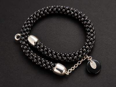 Elegant black beaded bracelet with silver accents.