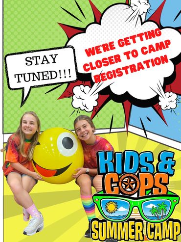 Two girls are posing for a camp photo.