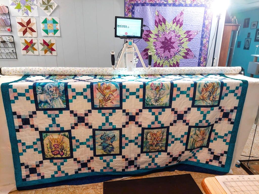 Longarm quilting machine with fairy quilt.