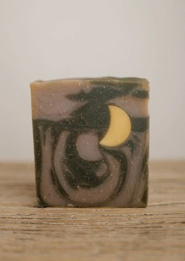 Handcrafted soap with swirls and a crescent moon design.