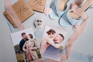 Wedding items including vows books, shoes, rings, and invitations of Sydney and Jackson.