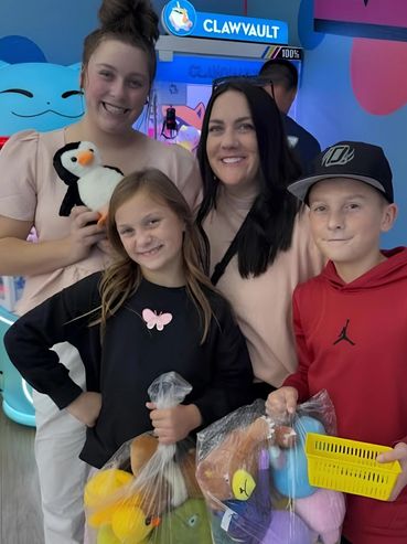 Family holding their plushie wins.