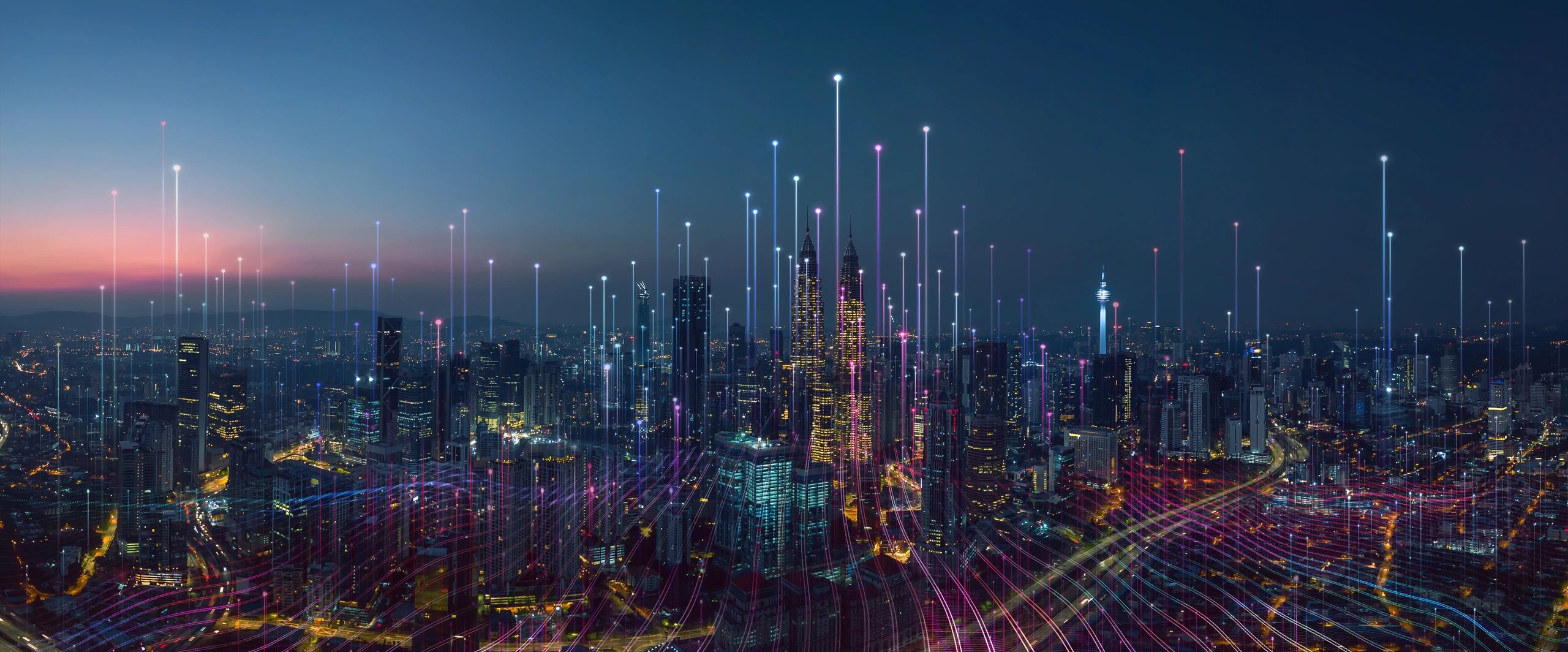 City skyline at night with digital light trails and data points.