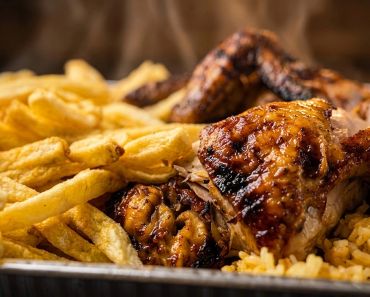 Authentic Portuguese charcoal-grilled chicken platter served with fresh-cut fries and yellow rice
