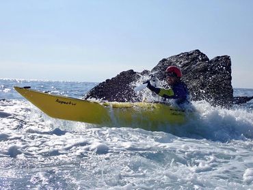 Adventurous fun- kayaker in a sea kayak in waves!