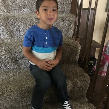 Boy sitting on stairs.