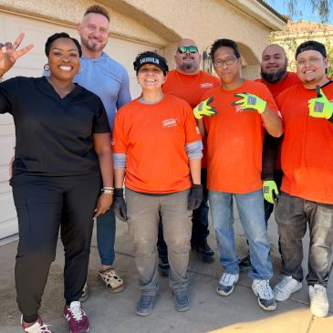 A group of smiling people posing outdoors.
