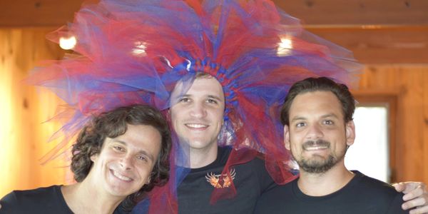 Edgard, Tomás, and Gustavo. Tomás is wearing a tutu on his head.
