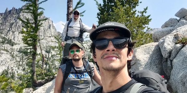 Tomás, Gustavo, and Edgard hiking in the Enchantments on a clear day