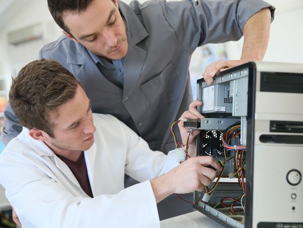 two man repairing a computer.