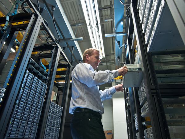 a man installing a server.