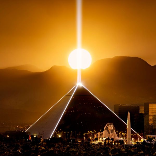 Sunset perfectly aligned with the Luxor pyramid in Las Vegas, casting a golden glow.