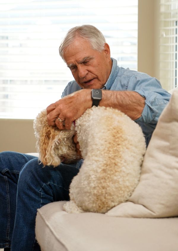Elderly man with his dog wearing a Help Button