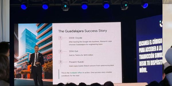 Young woman giving a presentation to an attentive audience in a casual setting.