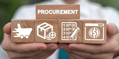Wooden blocks with procurement icons held by a person.