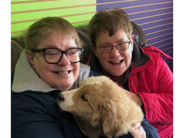 Julie and Chip with Julie’s sister, captured during Chip’s early days as a puppy—marking the beginni