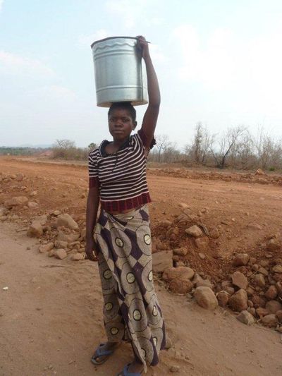 Thandiwe, like many of her peers, carries water daily for her family.