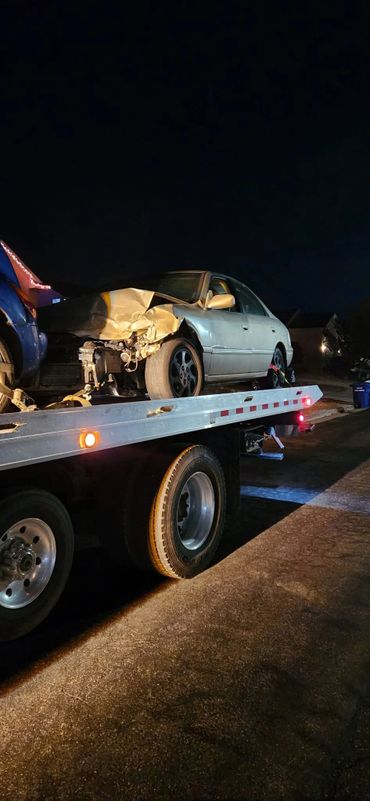 Tow truck towing broken down car