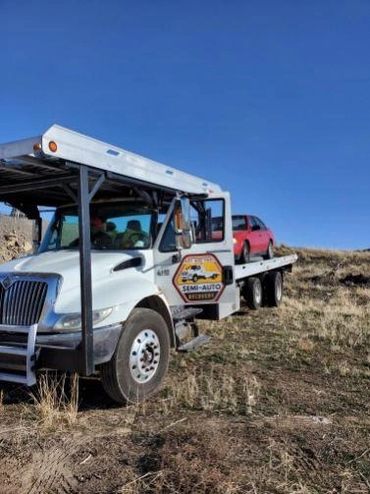 Tow truck towing broken down car