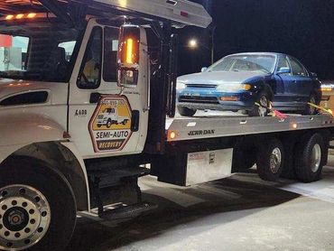 Tow truck towing a broken down car