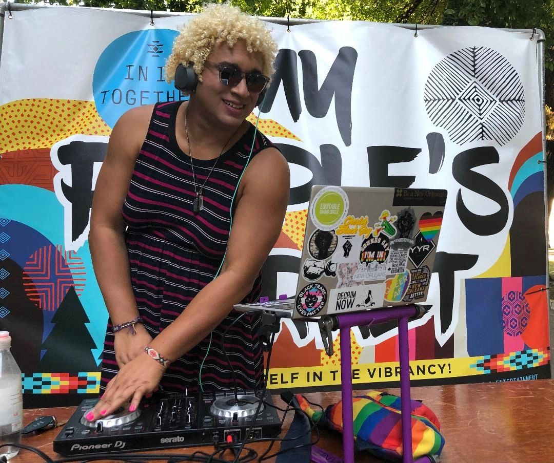 Bianca stands over her DJ controller and laptop.