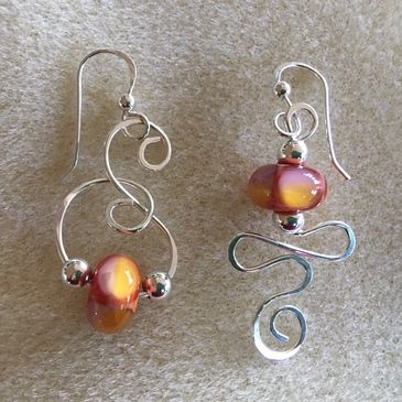 Earrings with glass bead and sterling sliver wire work, both created by Jamie McKay c2017